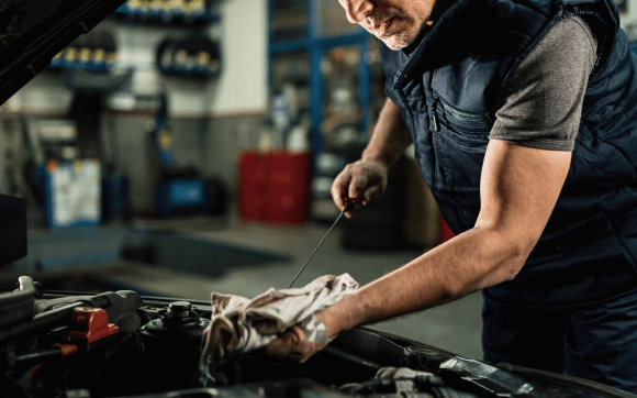 Mechanic working on a cars engine bay